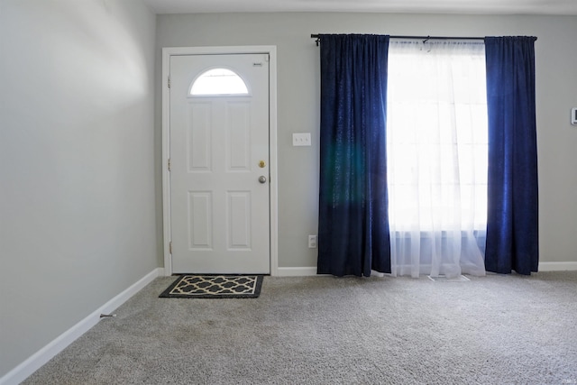 carpeted entrance foyer with a healthy amount of sunlight and baseboards