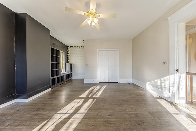 spare room with ceiling fan, baseboards, and wood finished floors