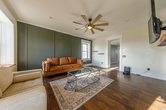 living room featuring wood finished floors, a ceiling fan, and ornamental molding