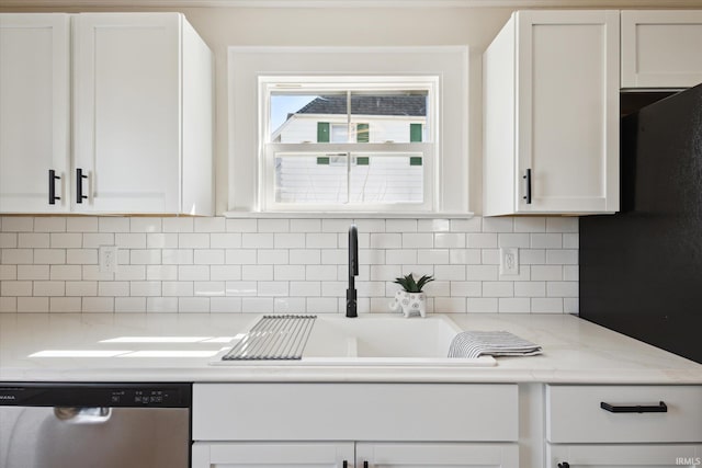 kitchen featuring a sink, white cabinetry, light countertops, and stainless steel dishwasher