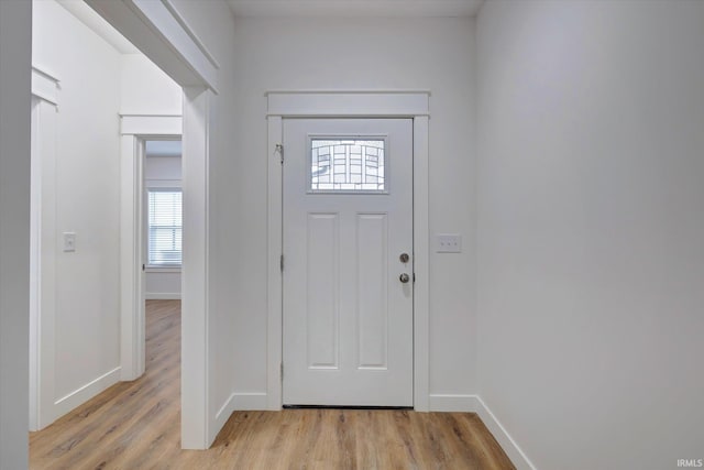 entryway with baseboards and light wood-style floors