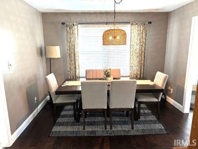 dining room featuring wood finished floors and baseboards