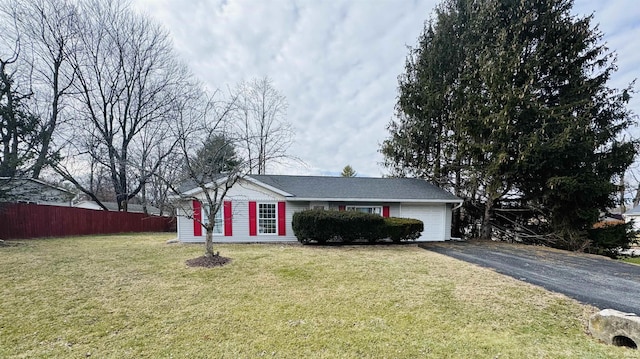 ranch-style house featuring aphalt driveway, an attached garage, a front yard, and fence