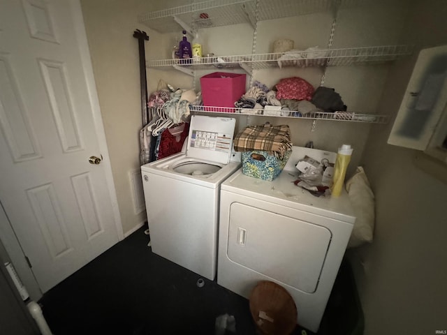 laundry room featuring electric panel, laundry area, and washing machine and dryer