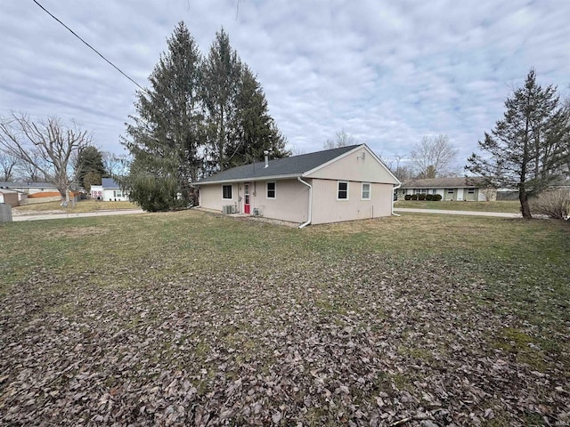 back of house with a lawn