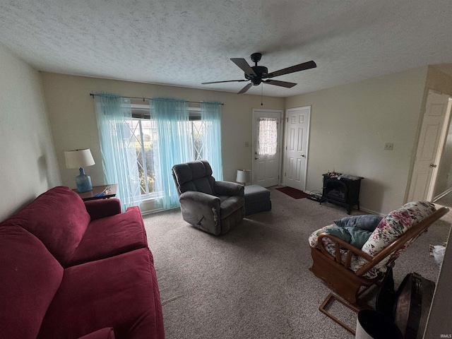 carpeted living room with a textured ceiling and a ceiling fan