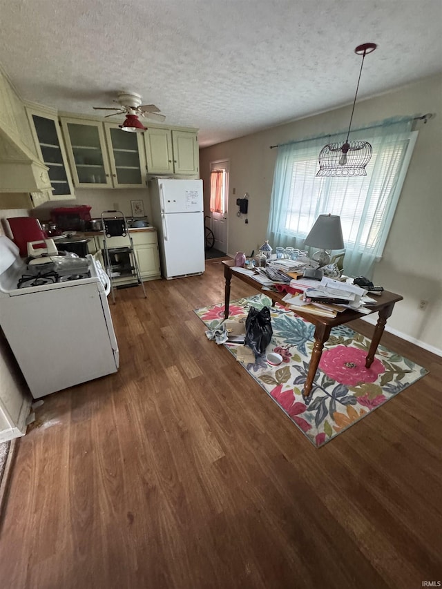 dining room featuring ceiling fan, baseboards, a textured ceiling, and wood finished floors