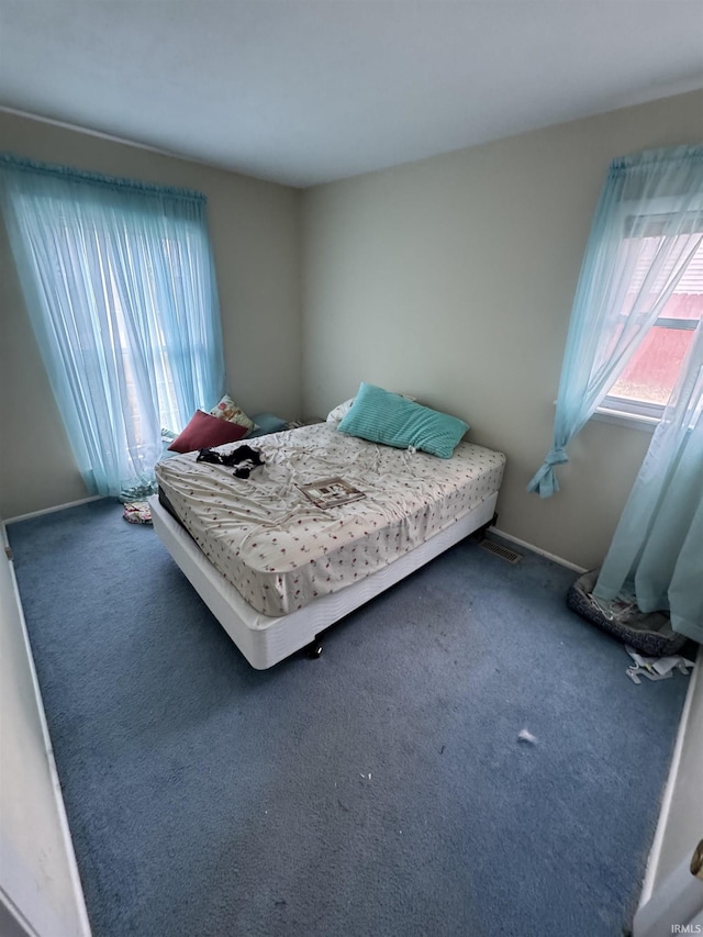 carpeted bedroom featuring baseboards