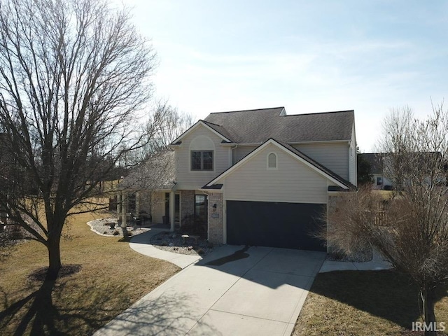 traditional home with a front lawn, an attached garage, brick siding, and driveway