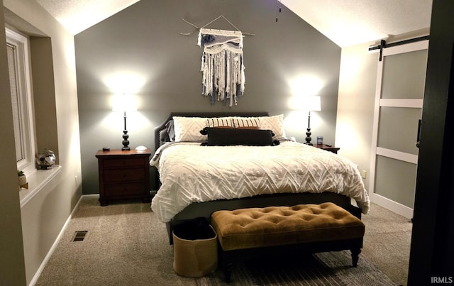 carpeted bedroom with a barn door, baseboards, visible vents, and vaulted ceiling