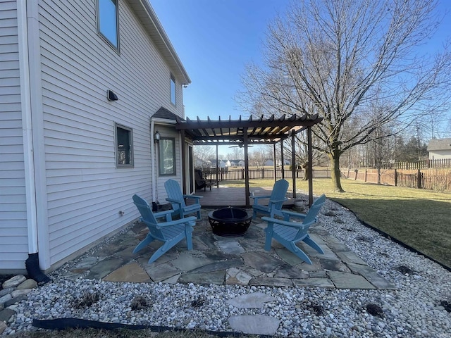 view of patio with fence, a fire pit, and a pergola