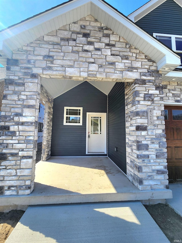 doorway to property featuring stone siding