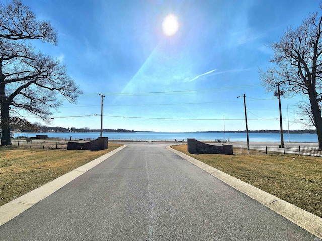 view of road with a water view and street lighting