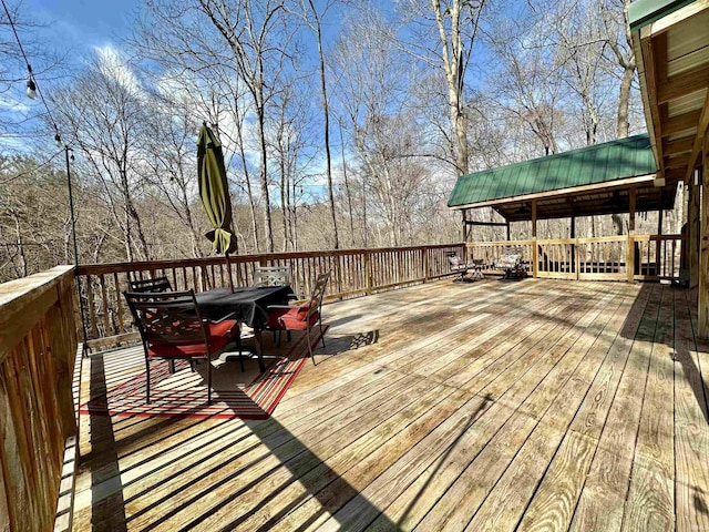 wooden terrace with outdoor dining space