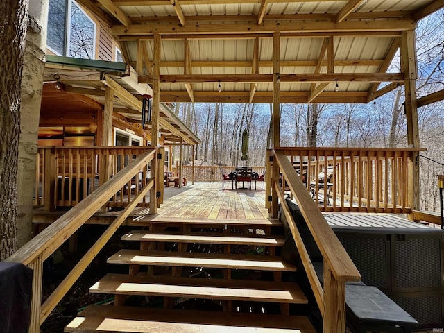 wooden deck featuring stairs and outdoor dining area