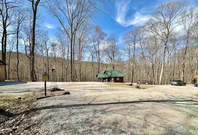 view of yard featuring a wooded view