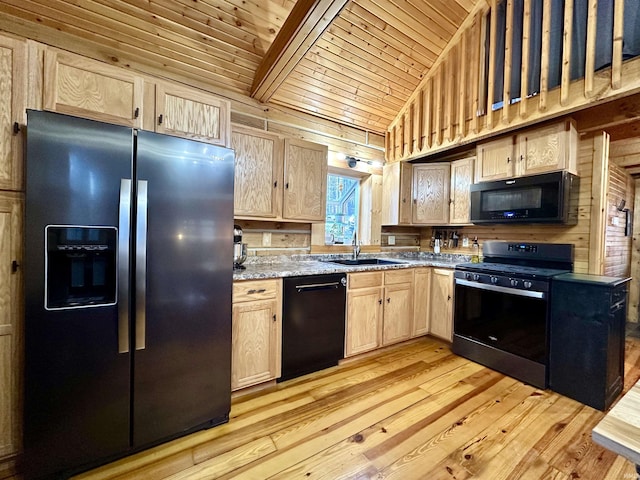 kitchen featuring black appliances, light brown cabinets, a sink, light wood finished floors, and vaulted ceiling with beams