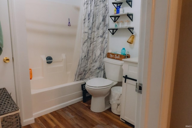 bathroom featuring vanity, shower / tub combo, toilet, and wood finished floors