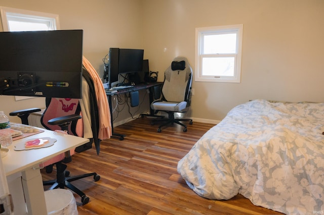 bedroom with wood finished floors and baseboards