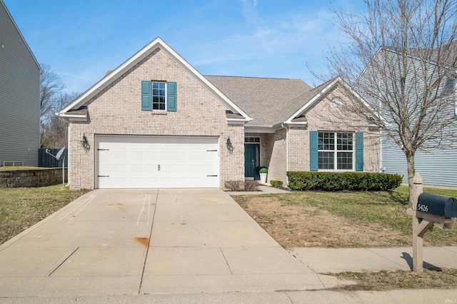 view of front of property with a front yard, brick siding, driveway, and a shingled roof