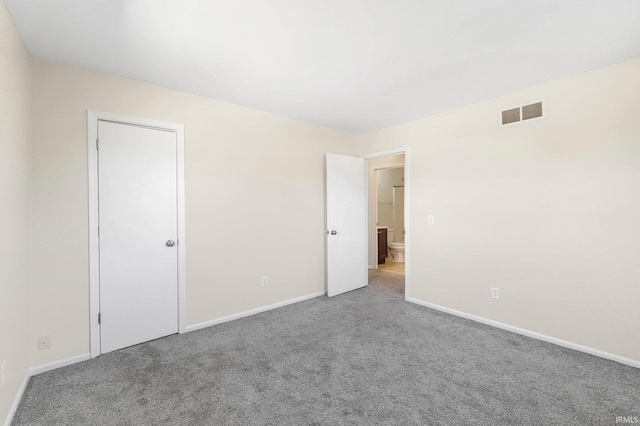 unfurnished bedroom with visible vents, baseboards, and carpet floors