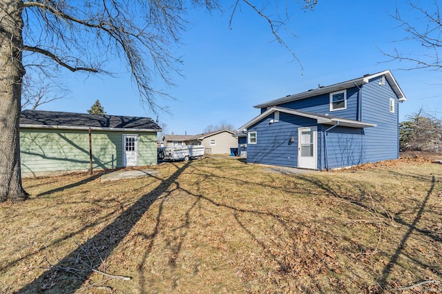 rear view of property featuring a yard