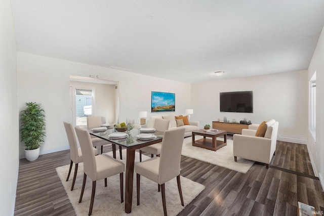 dining area with dark wood finished floors and baseboards