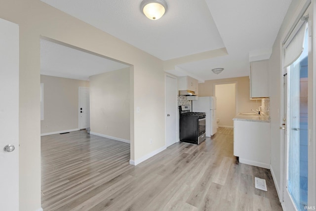 interior space with light wood finished floors and baseboards