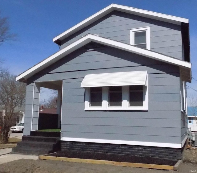 view of side of property featuring entry steps