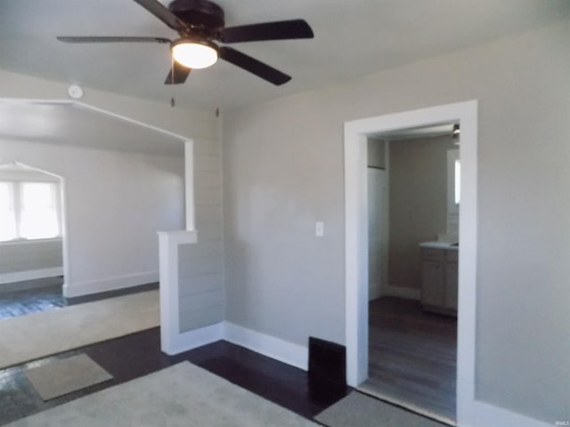 empty room featuring baseboards and a ceiling fan