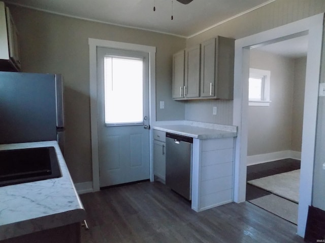 kitchen with dark wood-type flooring, dishwasher, light countertops, and freestanding refrigerator