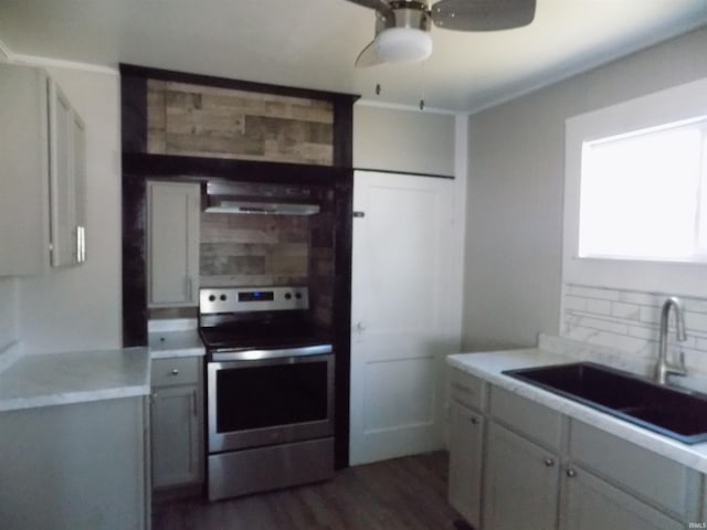 kitchen with stainless steel electric range, ceiling fan, a sink, extractor fan, and tasteful backsplash