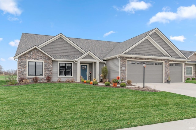 craftsman-style house featuring a front yard, a garage, stone siding, and driveway