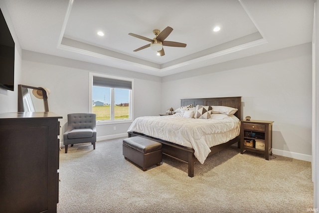 bedroom with a raised ceiling and baseboards