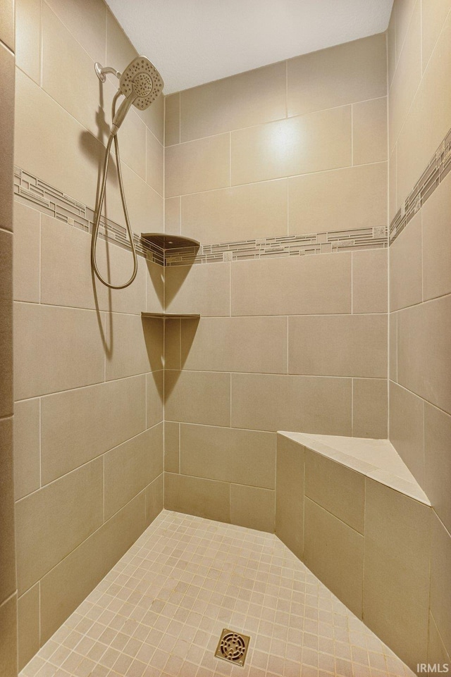 bathroom with tiled shower