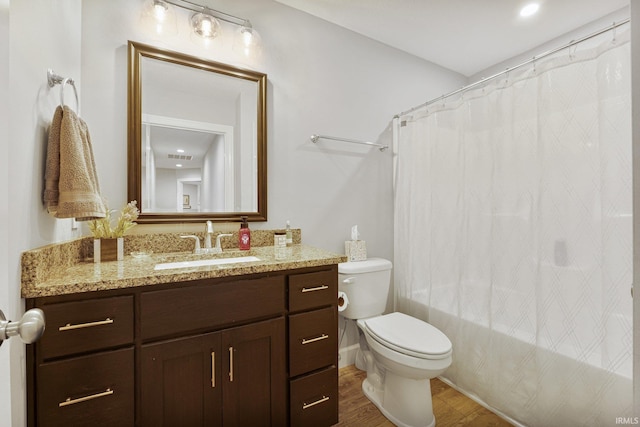 full bath featuring shower / bath combo with shower curtain, toilet, wood finished floors, and vanity