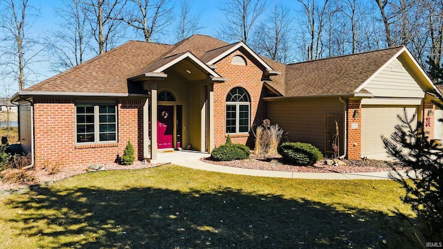 view of front of property with brick siding, an attached garage, a front yard, and roof with shingles