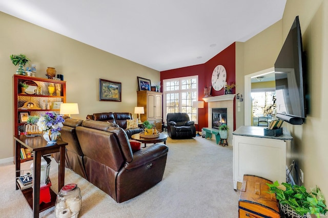 living area featuring light colored carpet and a tile fireplace