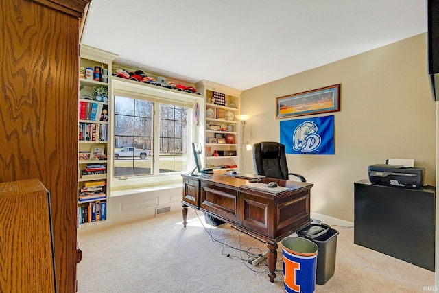 carpeted home office featuring visible vents and baseboards