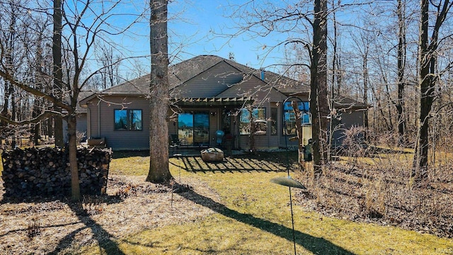 back of house with a shingled roof