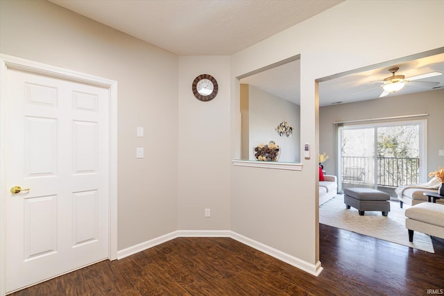 hall with dark wood-style floors and baseboards