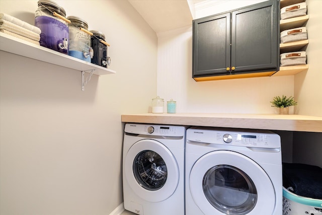 washroom with washer and dryer and cabinet space