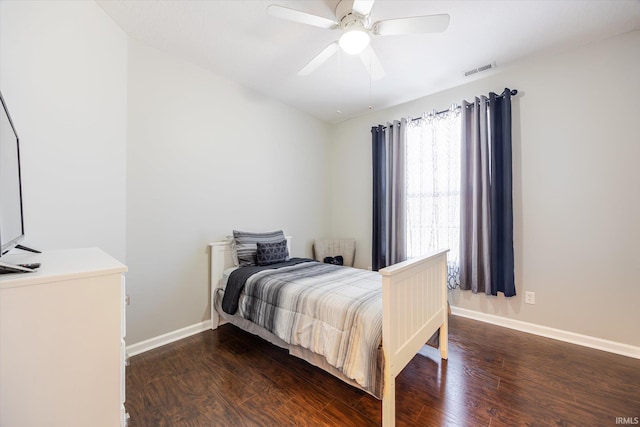 bedroom featuring visible vents, baseboards, wood finished floors, and a ceiling fan