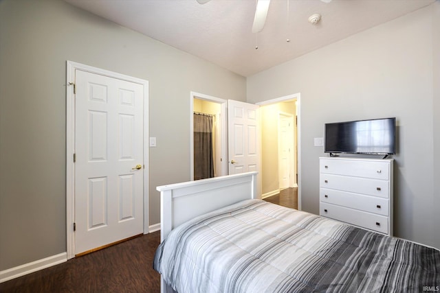 bedroom with dark wood-type flooring and baseboards