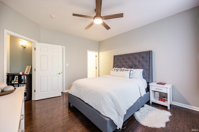 bedroom with a ceiling fan, dark wood-type flooring, and baseboards