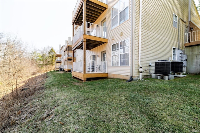 exterior space featuring central air condition unit and a lawn