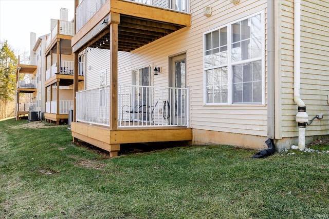 exterior space featuring a lawn and central AC unit