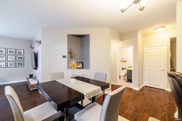 dining room with dark wood finished floors and baseboards