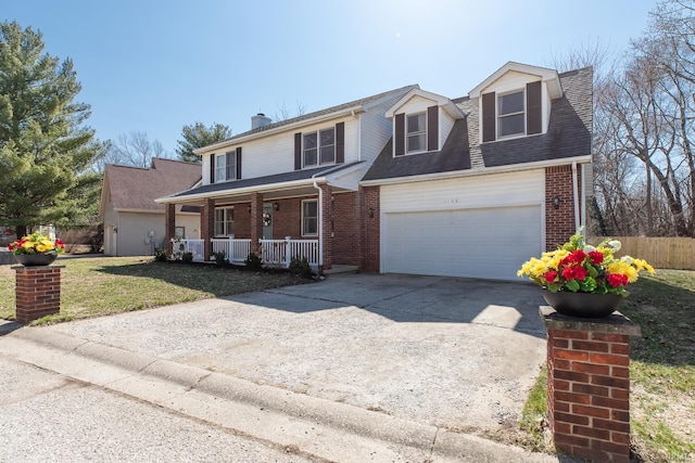 traditional home with brick siding, covered porch, an attached garage, and concrete driveway