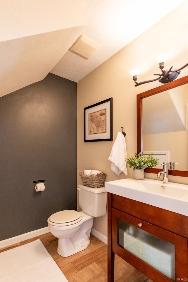 bathroom featuring vanity, wood finished floors, baseboards, a ceiling fan, and toilet